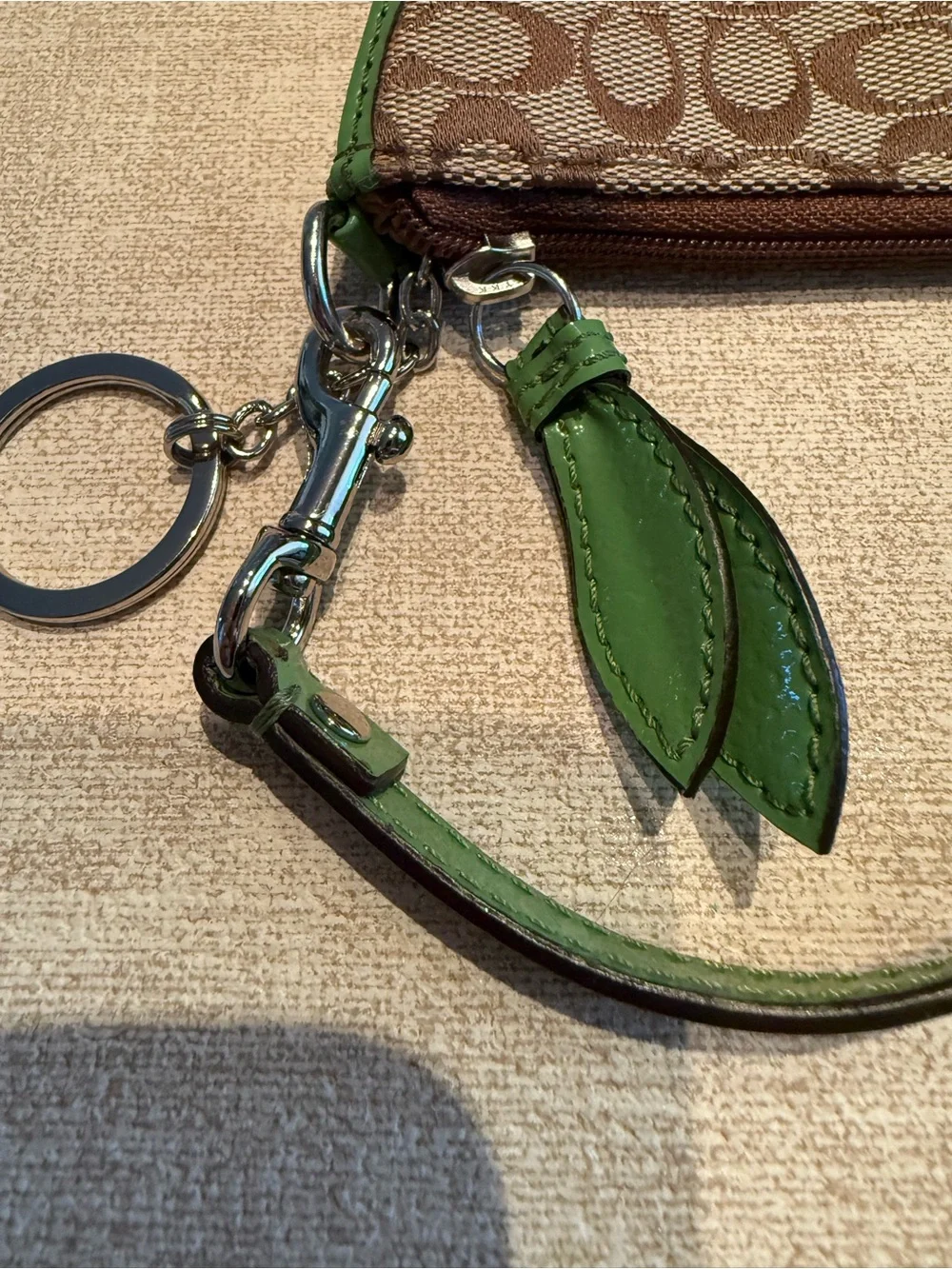Coach Brown Signature Wristlet with Green Trim and Daisy Motif